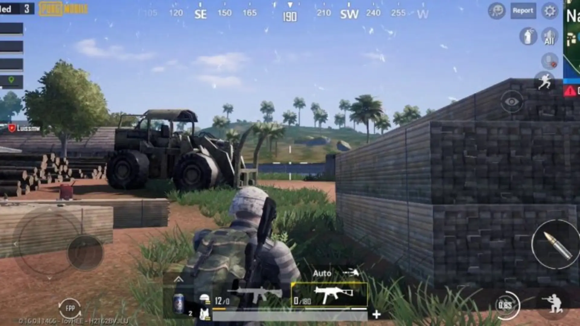 PUBG Mobile player taking cover beside a tractor on a tropical battlefield
